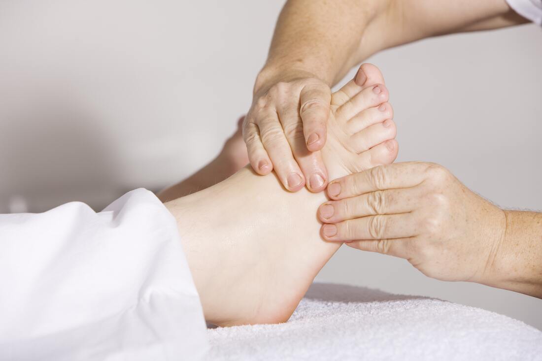 hands massaging feet